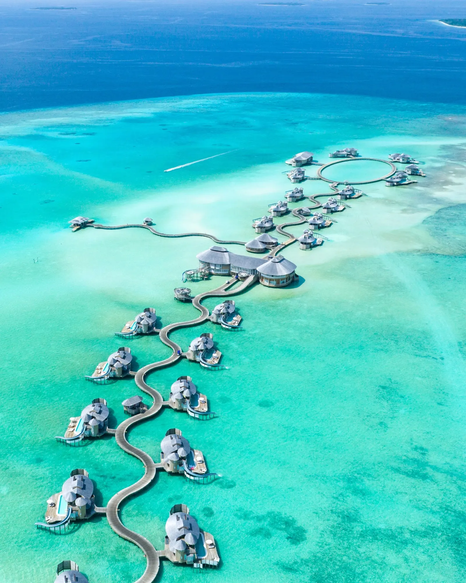 Aerial view of overwater villas on a turquoise lagoon